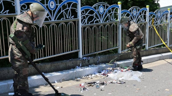 In a file photo, South Korean soldiers examine various objects of trash from a balloon believed to have been sent by North Korea, in Incheon, South Korea, on June 2, 2024