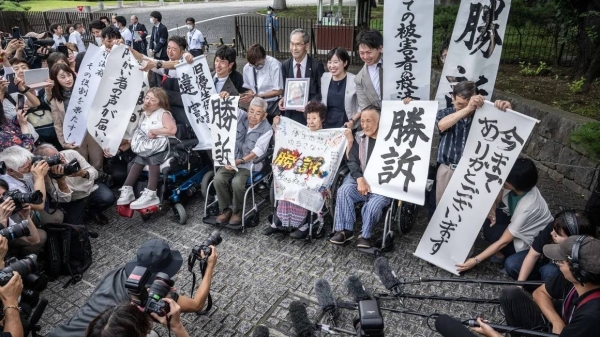 Plaintiffs who experienced forced sterilization celebrate with lawyers and supporters outside of the Supreme Court of Japan in Tokyo on July 3, 2024, after its ruling