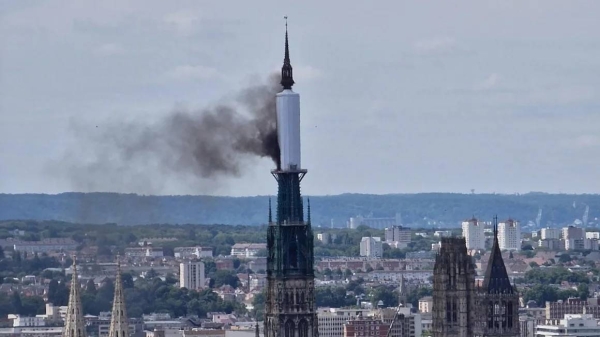 Smoke billows from the spire of Rouen Cathedral in Rouen, northern France on Thursday
