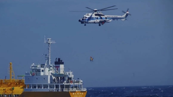 Japan Coast Guard personnel airlift a woman who survived overnight at sea after she drifted miles away from a beach on a floating ring on July 10, 2024