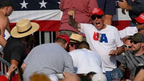 The crowd reacts after shots rang out at a Donald Trump rally Saturday