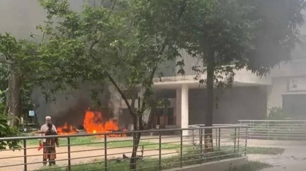 A fire burns outside BTV headquarters in Bangladesh