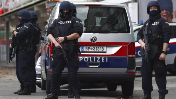 FILE - Police officers guard the scene in Vienna, Austria