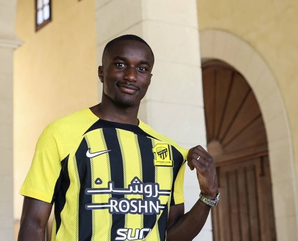 Moussa Diaby poses in his new Al-Ittihad jersey at the club's summer camp in Alicante, Spain.