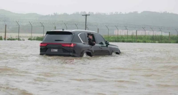 Kim was shown to be travelling through a flooded area in a black Lexus car