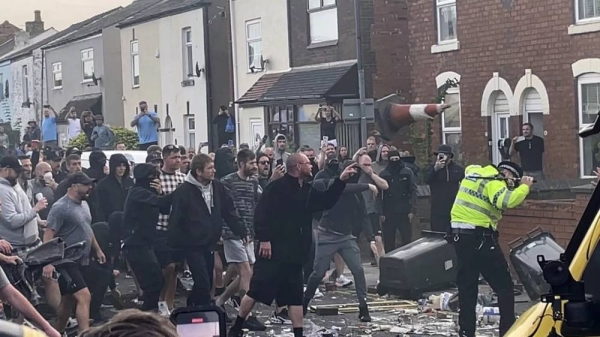 An unruly crowd clash with police on Tuesday in Southport, northwest England, near where three girls were stabbed to death in a dance class the day before