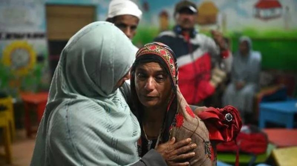 At relief camps and hospitals, survivors wait for news of their relatives