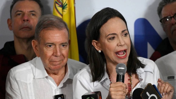 Venezuelan opposition leader Maria Corina Machado talks to the media, accompanied by opposition presidential candidate Edmundo Gonzalez Urrutia, following the election results in Caracas on July 29, 2024