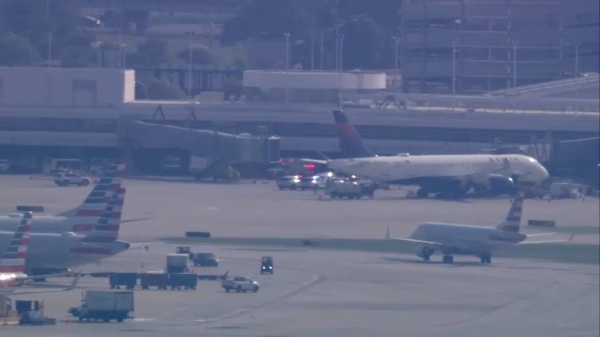 Emergency vehicles are seen Chicago O'Hare International Airport after a dead woman was found entangled in baggage machinery