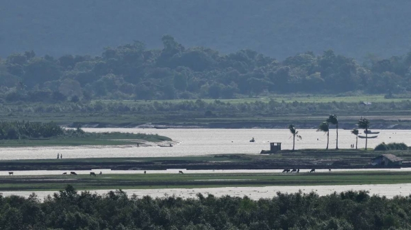 People are seen in Myanmar's Maungdaw township from the Teknaf area of Bangladesh, at the Myanmar-Bangladesh border on June 27, 2024