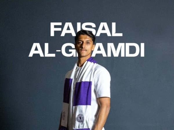 Faisal Al-Ghamdi in the club's white and purple jerseys.