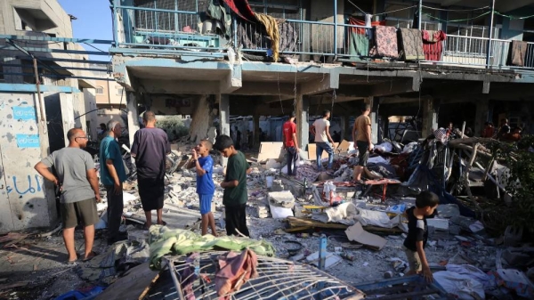 Palestinians check the grounds of a school after an Israeli airstrike in Nuseirat, Gaza Strip, on September 11, 2024