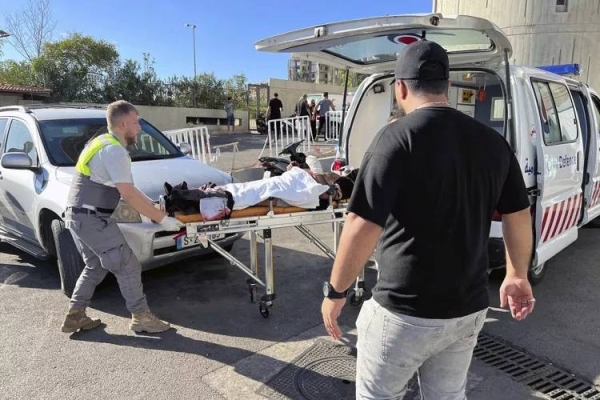 Civil Defense first-responders carry a wounded man whose handheld pager exploded at al-Zahraa hospital in Beirut, Lebanon, Tuesday, Sept. 17, 2024