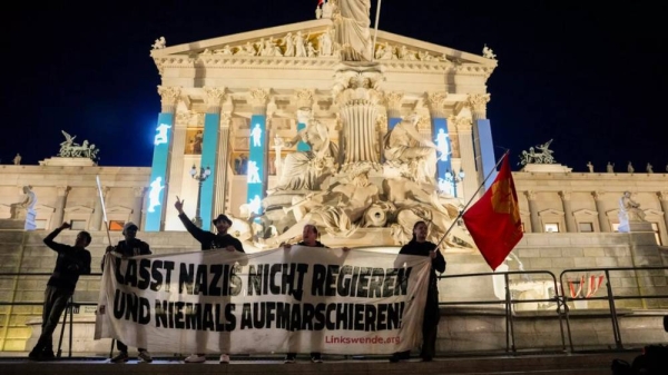 Anti right wing protesters shout slogans and hold an banner that reads 'Don't let Nazis rule and never let them march' in Vienna, Austria, Sunday