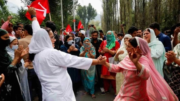 Supporters of the National Conference celebrate as the party leads in Jammu and Kashmir