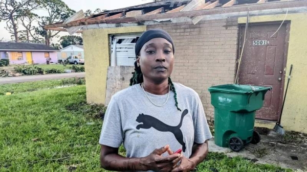 Crystal Coleman stands in front of the ruins of her home in south Florida