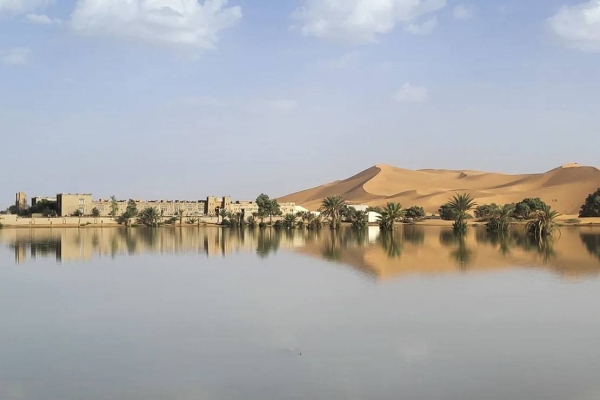 Buildings along a lake filled by heavy rainfall in the desert town of Merzouga on October 2, 2024