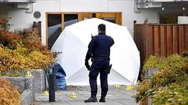 Forensic police stand at the scene where Swedish rapper Einar was shot to death, in Hammarby Sjostad district in Stockholm, Friday, Oct. 22, 2021