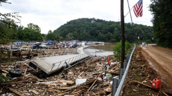 A damaged walkway lies on top of debris left by Hurricane Helene in North Carolina. 
