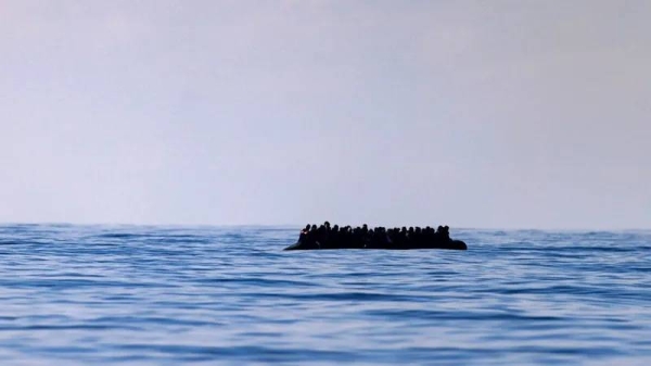 An overloaded dinghy carrying migrants crosses the English Channel in (file photo)