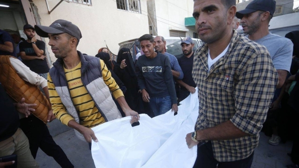 Palestinians carry the bodies wrapped in shroud to Al-Aqsa Martyrs Hospital after an Israeli attack on Deir al Balah, Gaza on October 20.