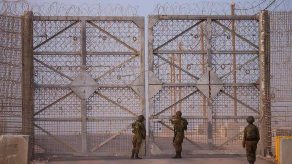 Israeli soldiers check a gate as they patrol along the Israel-Gaza border area on October 21, 2024