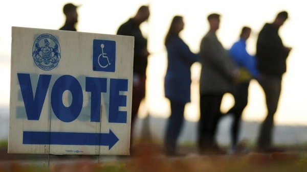 Voters wait in line to cast their ballots at Scranton High School in Scranton, Pennsylvania, on Election Day, Tuesday, November 5, 2024