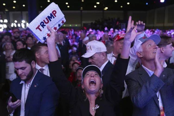 Supporters watch returns at a campaign election night watch party for Republican presidential nominee former President Donald Trump at the Palm Beach Convention Center