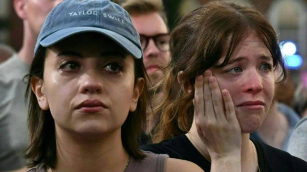 Harris supports frown and cry as they watch her speak