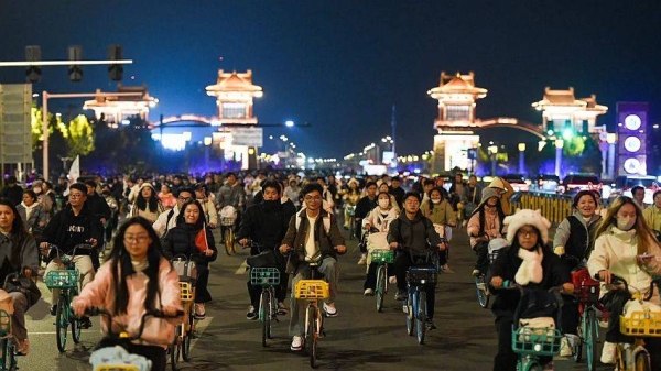 College students from Zhengzhou cycle to Kaifeng, 30 miles away, at night on November 9, 2024 in Henan Province of China