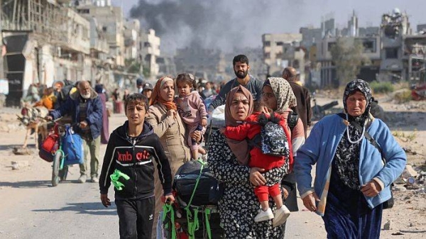 Palestinians displaced from shelters in Beit Hanoun cross into Jabalia, northern Gaza following Israeli army evacuation orders on November 12, 2024