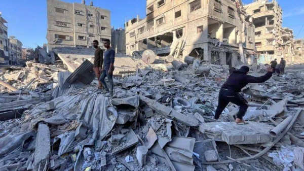 People go through the rubble looking for survivors after a residential building was flattened in an Israeli air strike in Beit Lahia in northern Gaza