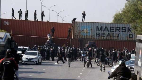 The city's roads have been blocked with shipping containers to stop the march reaching the centre