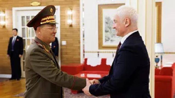 North Korean Defense Minister No Kwang Chol, left, and Russian Defense Minister Andrei Belousov, right, shake hands during their meeting in Pyongyang, North Korea, Friday