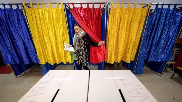 A woman casts her vote in a station in Bucharest, 1 December, 2024