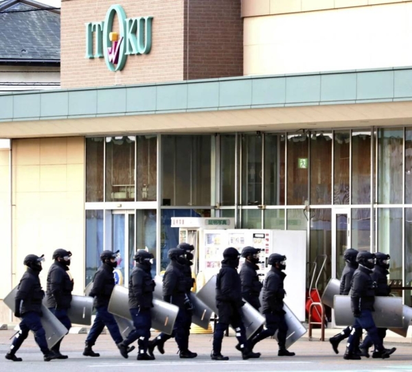 Police officers enter the supermarket to capture the bear in Akita, Japan on December 1, 2024