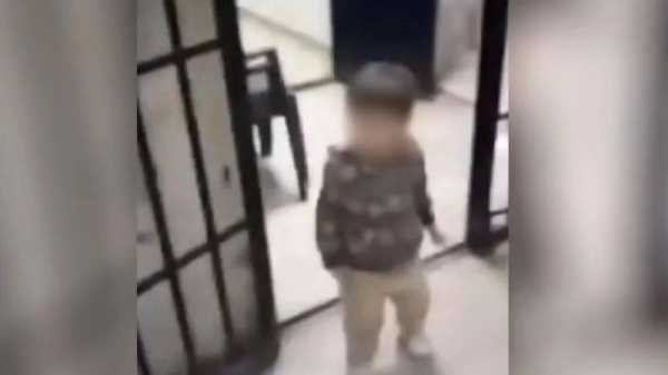 In one clip, a young child wanders through an open cell door