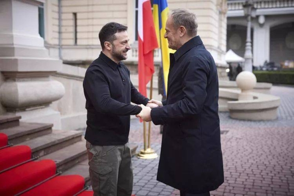 Ukrainian President Volodymyr Zelensky, left, shakes hands with Polish Prime Minister Donald Tusk in Lviv, Ukraine, Tuesday, Dec. 17, 2024