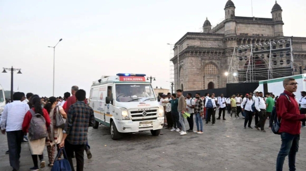 Passengers receive medical attention after a boat capsized off the coast in Mumbai, India on December 18