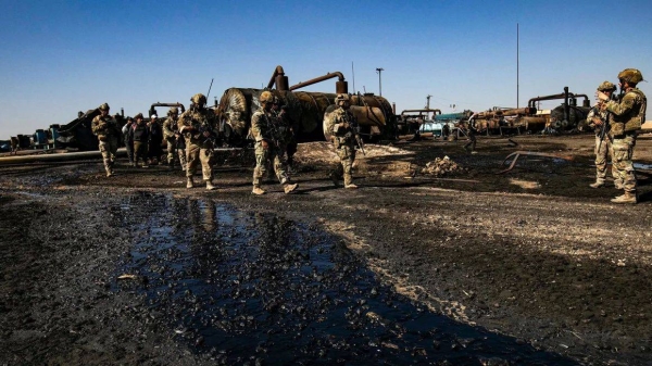 US soldiers inspect the site of reported Turkish shelling days earlier on an oil extraction facility on the outskirts of Rumaylan, in Syria's Kurdish-controlled northeastern Hasakeh province on October 28