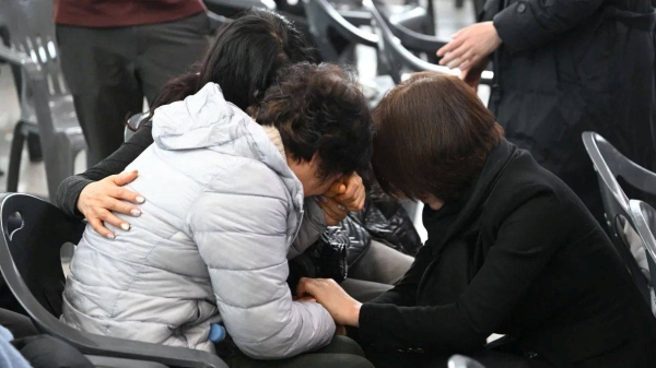 Relatives of passengers who died in the Jeju Air crash mourn their loved ones at Muan International Airport on December 30