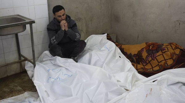 A Palestinian man sits in Al-Aqsa Hospital mourning relatives killed in overnight Israeli airstrikes on the Maghazi refugee camp on 28 December, 2024