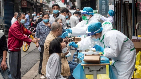 Medical workers test residents for Covid-19 in the city of Wuhan in China's central Hubei province on May 15, 2020