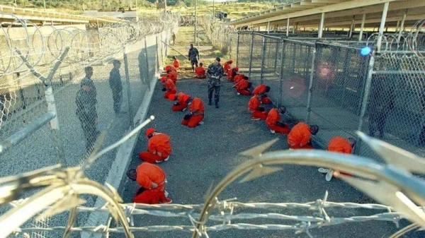 Detainees in jumpsuits at the Guantanamo Bay detention camp, January 2002