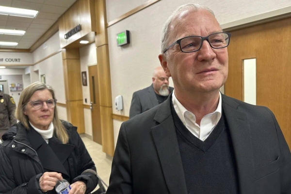 US Sen. Kevin Cramer speaks to reporters as his wife Kris Cramer, left, looks on, after the sentencing of his son, Ian Cramer on Monday