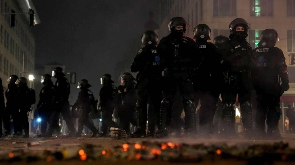 Police officers stand guard in the streets after fireworks celebrations in Berlin, Germany, Wednesday