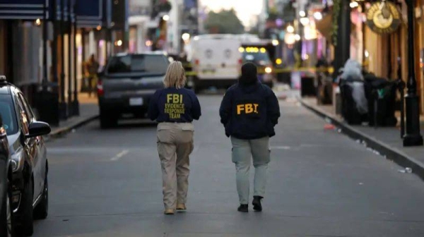 FBI agents pictured walking near the site of the New Orleans attack on New Year's Day