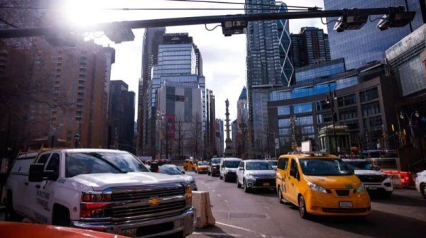 Cars drive under E-ZPass readers and license plate-scanning cameras on Columbus Circle as congestion pricing takes effect in New York City