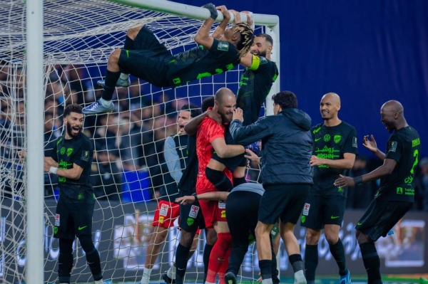 Al-Ittihad players celebrate with Serbian goalkeeper Predrag Rajković after the penalty shootout. 