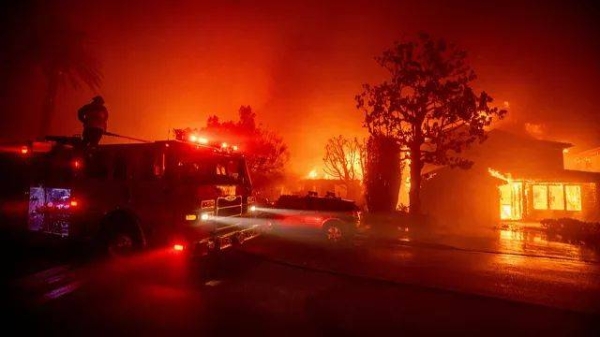 Fire crews battle the Palisades Fire as it burns multiple structures in the Pacific Palisades neighborhood of Los Angeles, Tuesday, Jan. 7, 2025